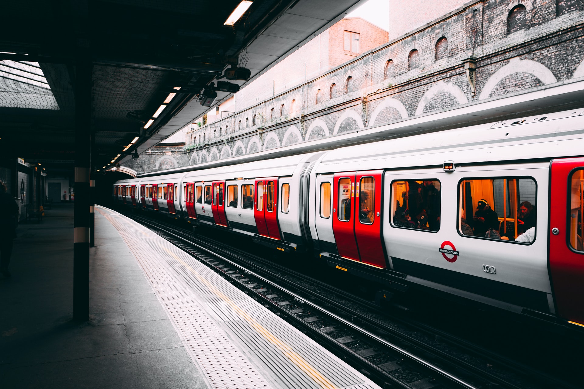 white and red train beside building at daytime